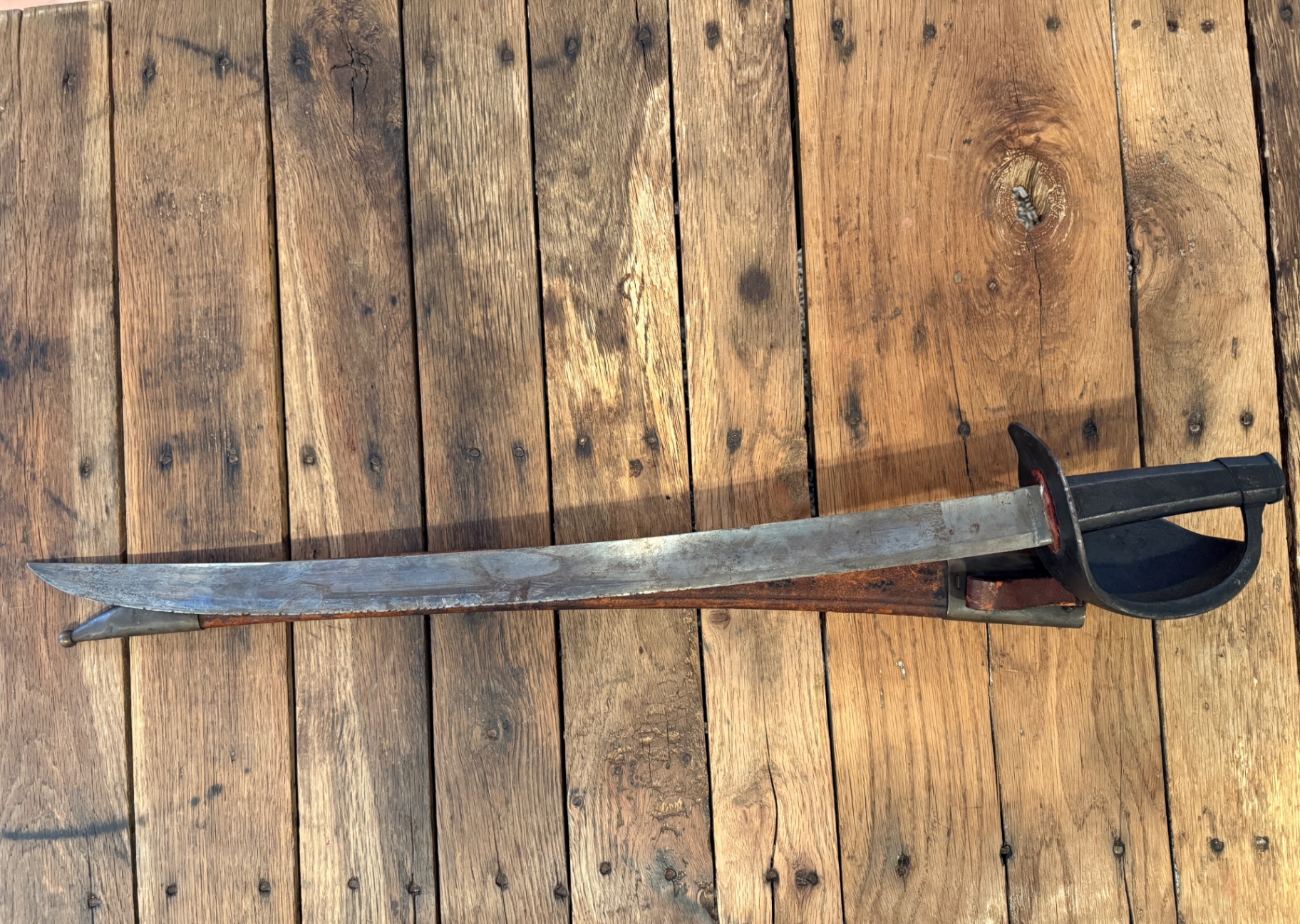 French naval cutlass M1833 drawn, with iron knuckle bow hilt and curved falchion blade